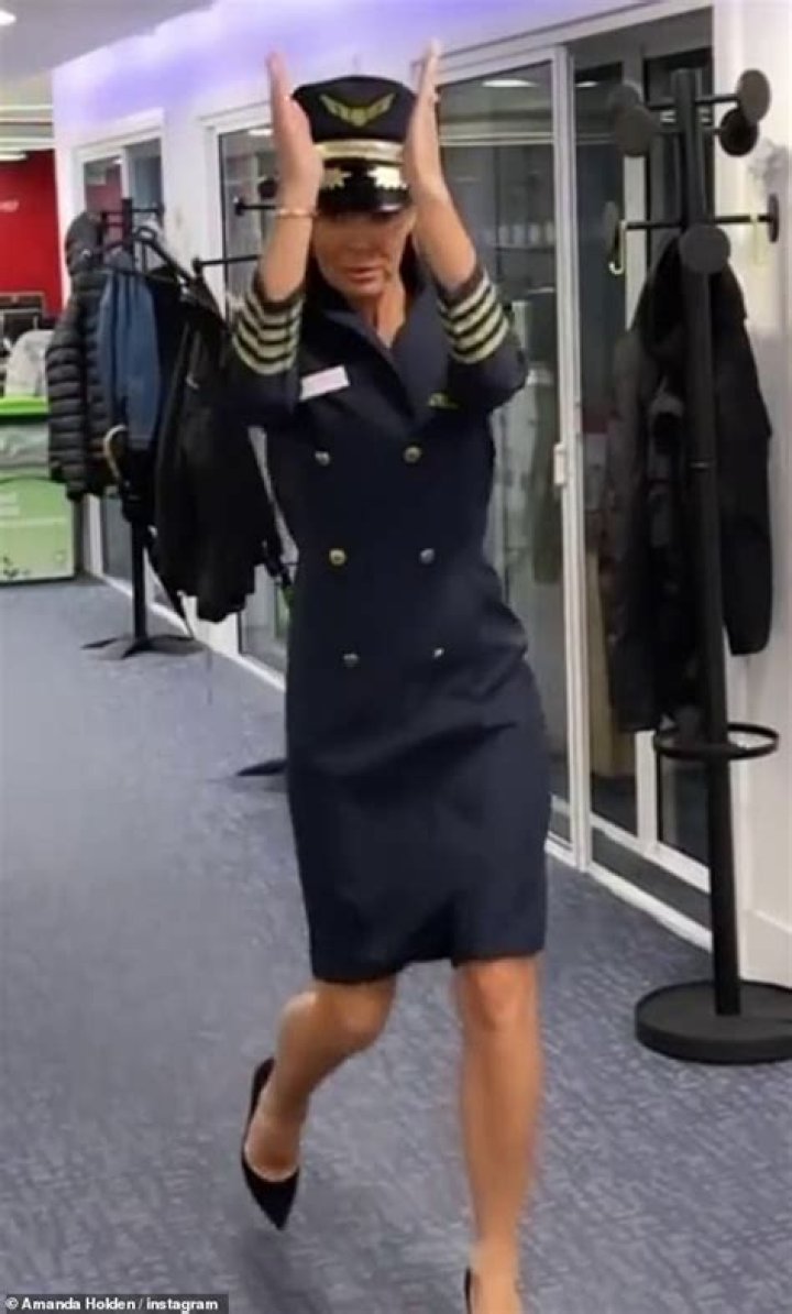 Amanda Holden dresses as sexy air hostess in a playful new video