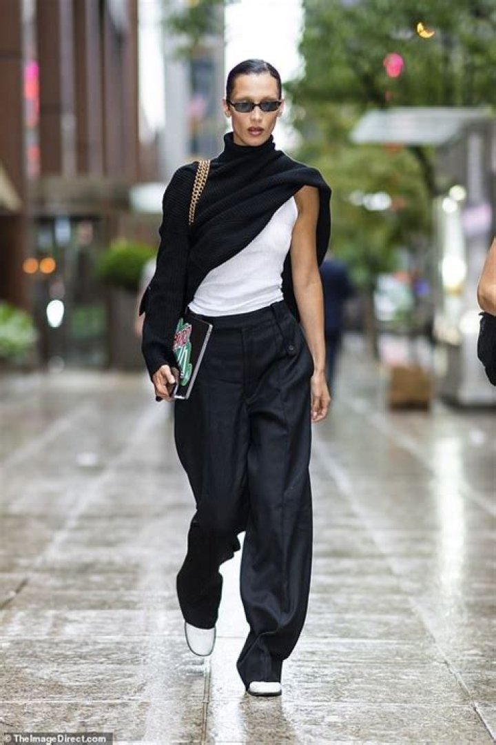 Bella Hadid appears to have her sweater only HALF on