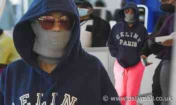 Cardi B keeps a low profile in a hoodie as she makes her way through JFK Airport in New York City