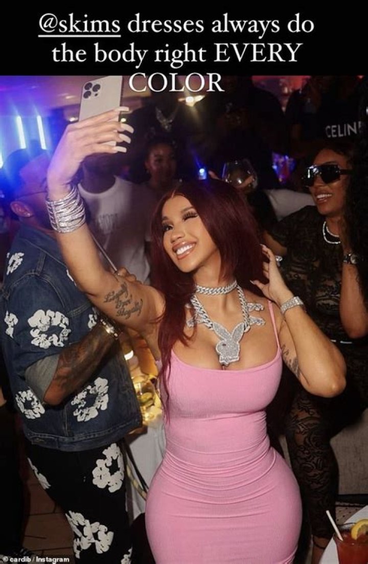 Cardi B wears nothing but a nude thong as she shows off her giant back tattoo in a racy topless twerking video