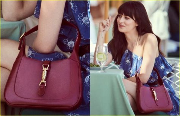 Dakota Johnson displays a Gucci Jackie 1961 bag for the fashion house's newest campaign