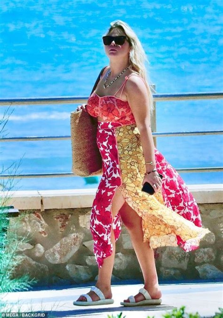 Emily Atack nails a summery look in a colourful floral dress in Marbella with her mum Kate Robbins