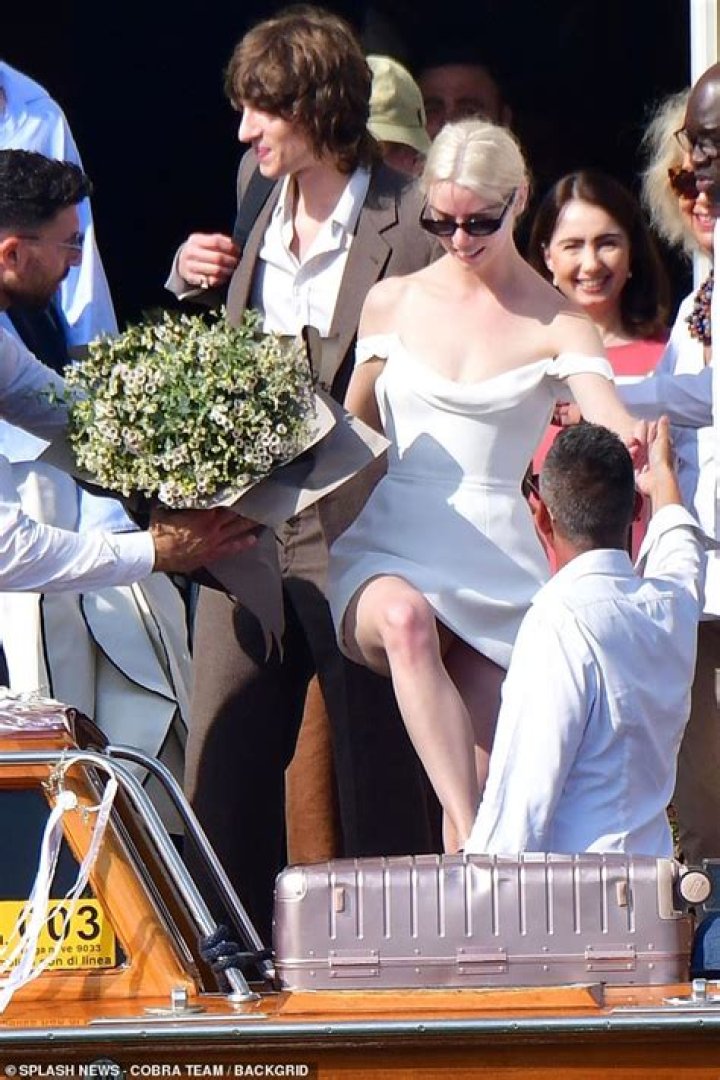 EXCLUSIVE: Anya Taylor-Joy gets steamy with husband Malcolm McRae on a Venetian water taxi while sporting corseted white mini for day two of their stunning Italian wedding