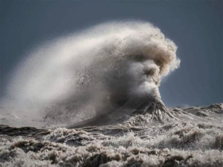 Face of Poseidon seems to appear on a giant wave during a thunderstorm