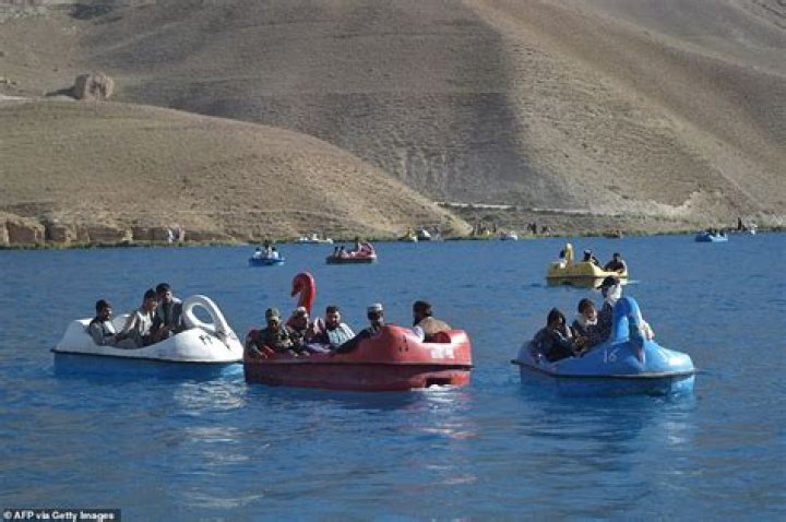 Heavily-armed Taliban fighters ride swan PEDALOS on Afghanistan lake
