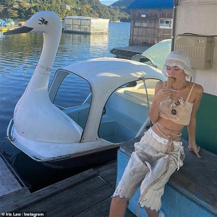 Iris Law showcases her toned midriff in a tiny beige crop top while travelling in Japan