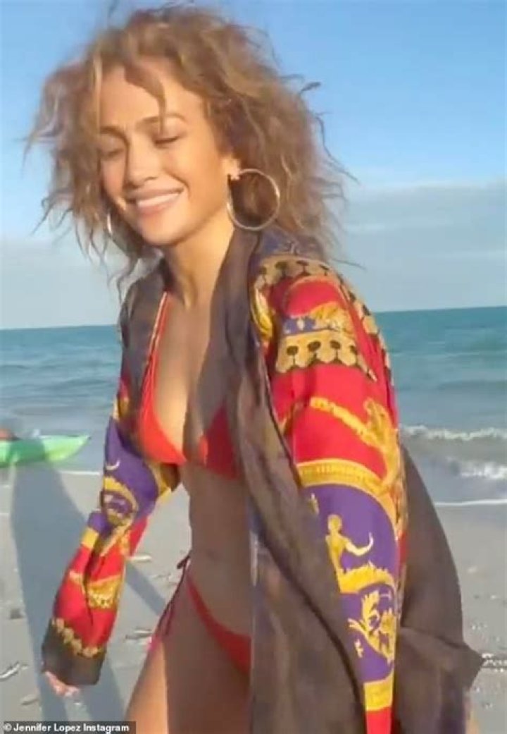 Jennifer Lopez, 51, poses in a red bikini on the beach and looks for 'Monday motivation'