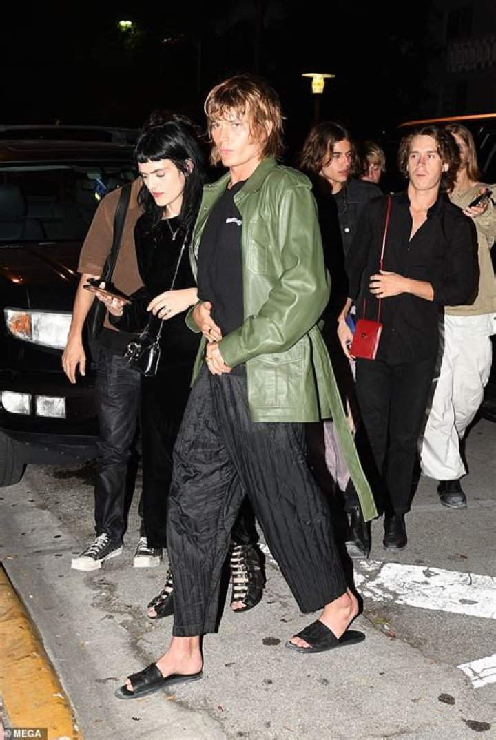 Jordan Barrett turns heads in a green leather coat as he attends Art Basel