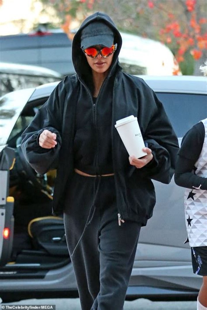 Kim Kardashian cuts a casual figure in cropped hoodie and sweatpants as she arrives with son Saint, eight, to support him at his basketball game