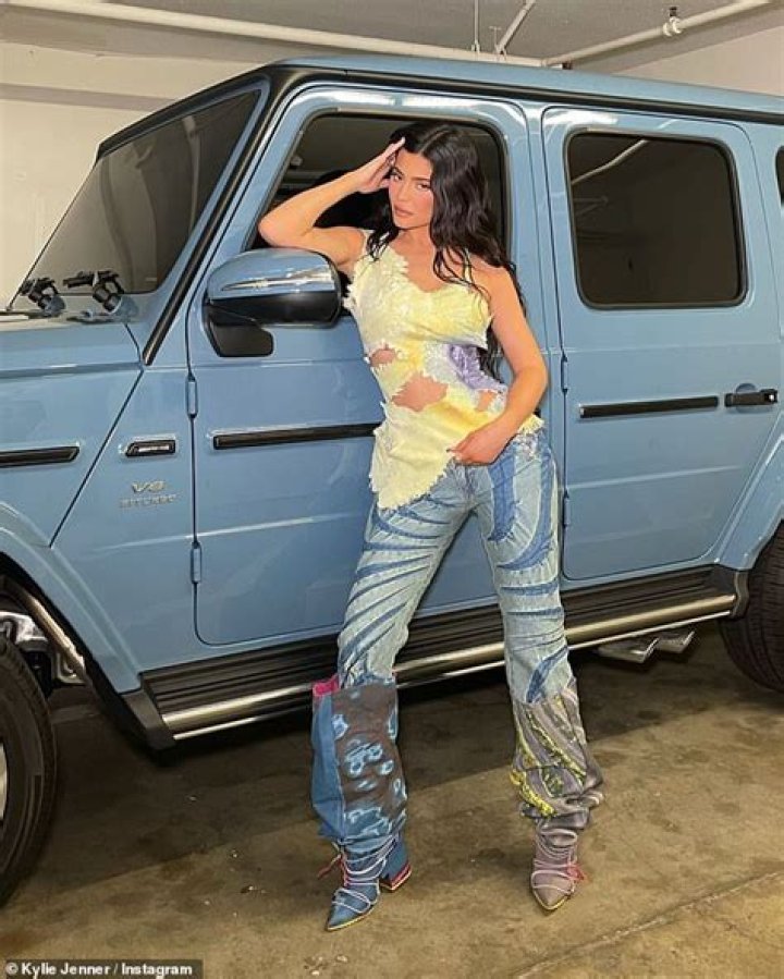 Kylie Jenner revs engines as she leans against her custom Mercedes Benz Wagon in 2000s-chic ensemble