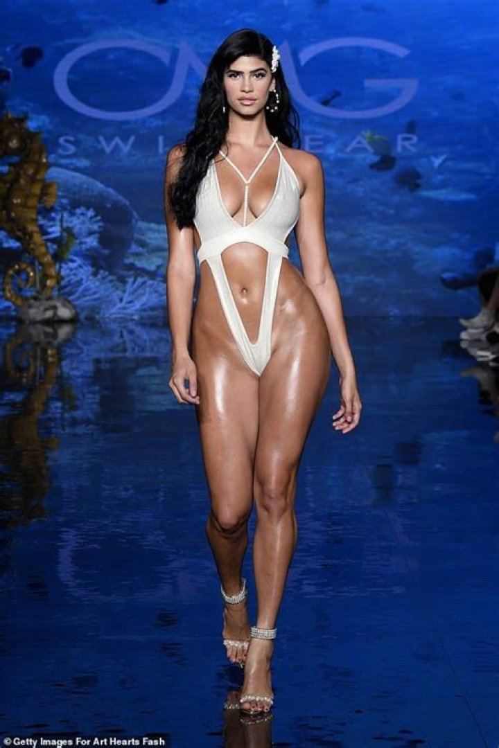 Lucciana Beynon is lathered with baby oil backstage at Miami Swim Week