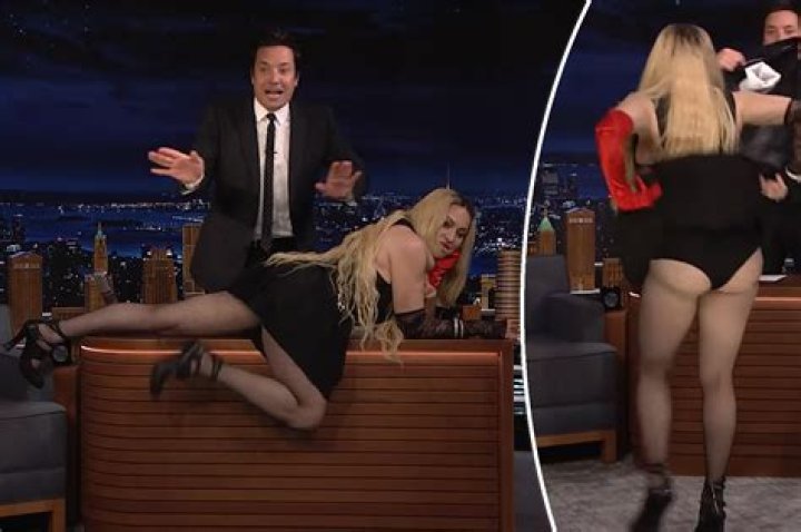 Madonna lies across desk, flashes audience on ‘Tonight Show’