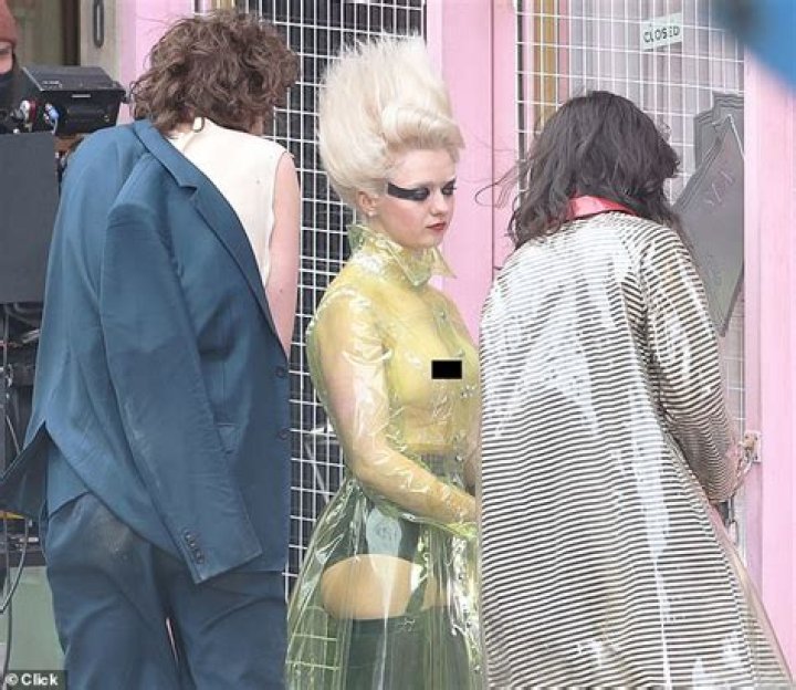 Maisie Williams goes topless beneath clear PVC coat as she transforms into punk icon Jordan