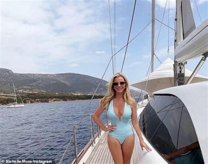 Michelle Mone showcases her slim figure in a plunging turquoise bikini on yacht in mystery location
