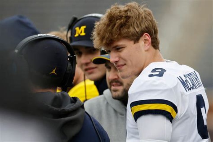 Michigan QB JJ McCarthy's father is slammed online after he appeared to fondle son's girlfriend