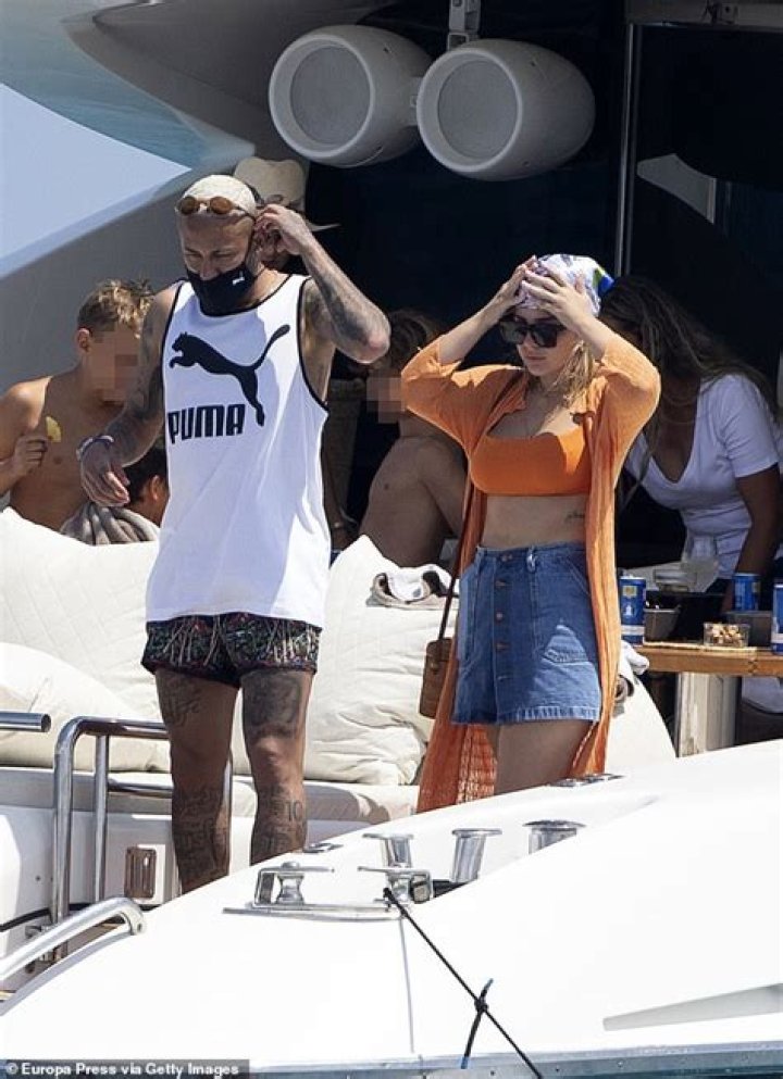 Neymar looks delighted as he embraces his swimsuit-clad ex Carolina Dantas on Ibiza yacht