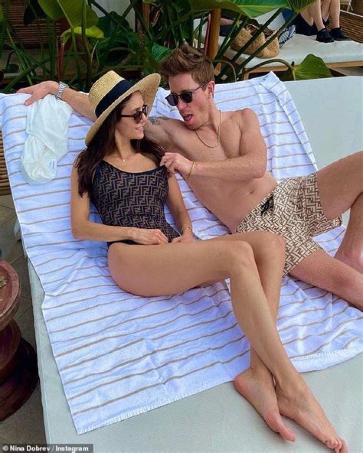 Nina Dobrev poses in a Fendi swimsuit as her boyfriend Shaun White goes shirt free