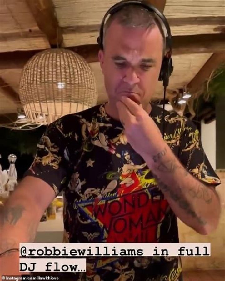 'Not afraid to be sexy': Robbie Williams poses shirtless and delivers a series of smouldering poses