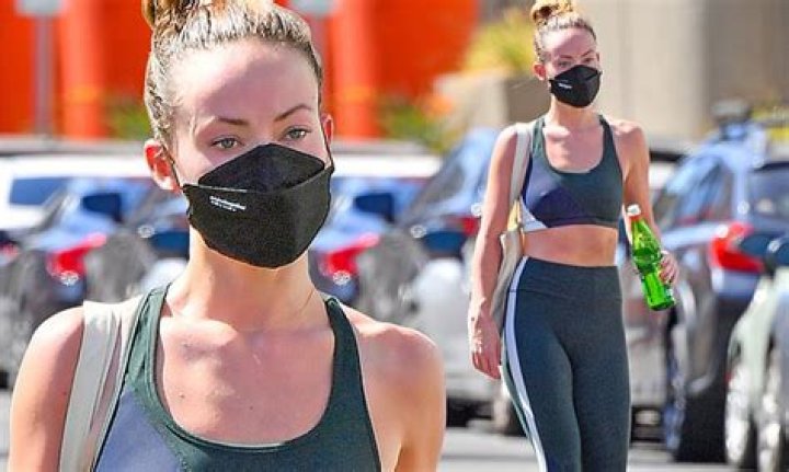 Olivia Wilde shows toned abs in sports bra after hitting gym... while beau Harry Styles is on tour