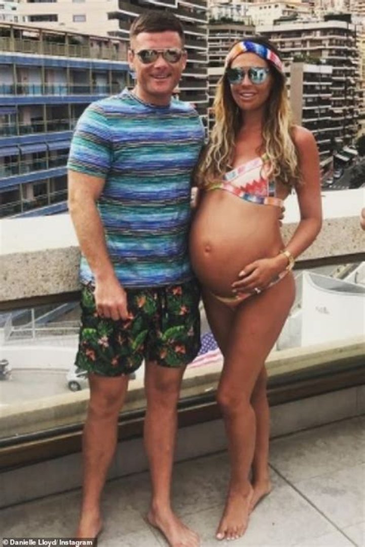 Pregnant Danielle Lloyd shows off her budding bump as she laps up the sunshine in a bikini