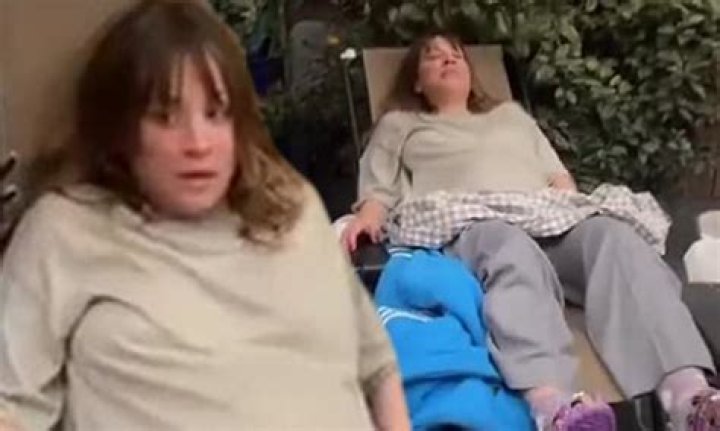 Pregnant Kaley Cuoco looks uncomfortable as she leans back in a lawn chair in her backyard