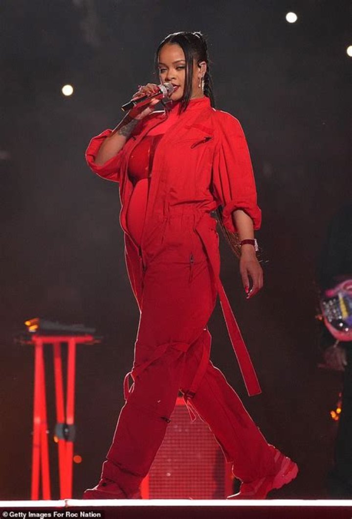 Pregnant Rihanna gives nod to André Leon Talley with iconic red coat during Super Bowl show