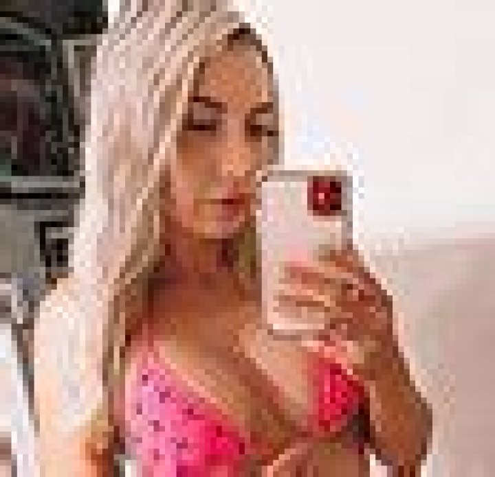 Rebecca Lobie flaunts her pert derrière as she washes her car in a VERY risqué photo