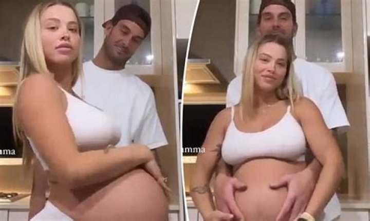 Tammy Hembrow shows off her giant baby bump as she cuddles up with fiancé Matt Poole