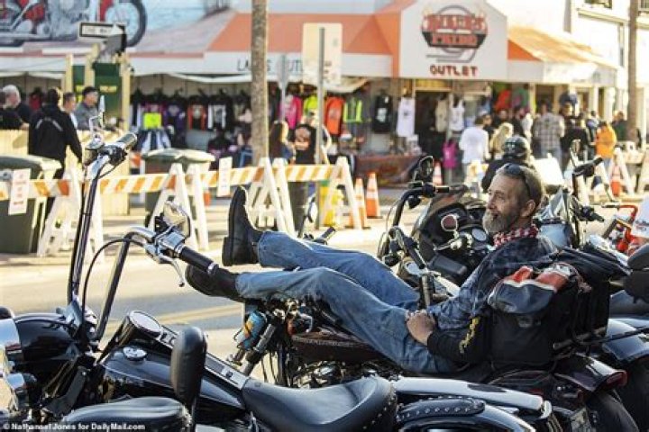 Tens of thousands of leather-clad bikers flex their defiance on Daytona Beach