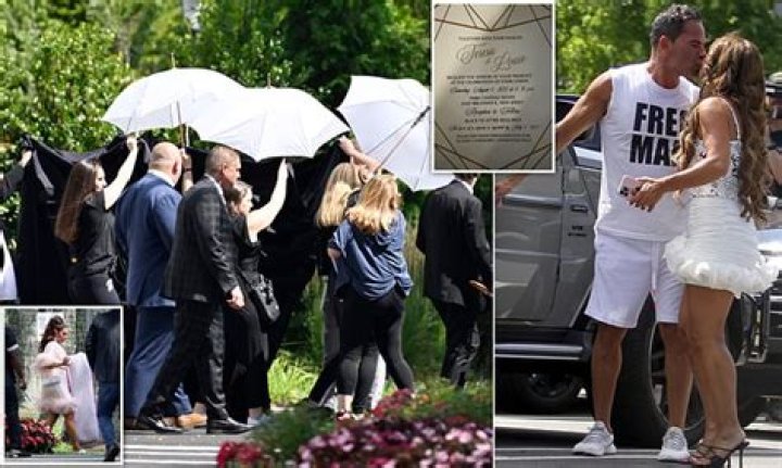 Teresa Giudice is protected by an entourage carrying umbrellas as she steps out for wedding